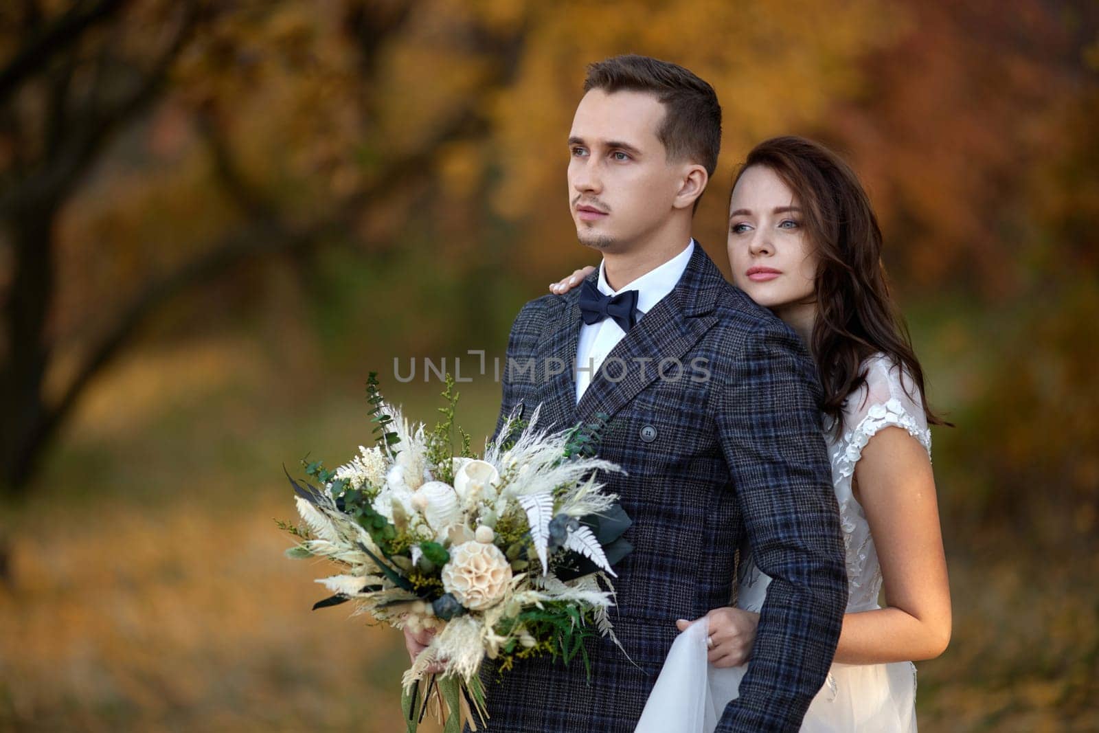 bride in white wedding dress and groom outdoor by erstudio