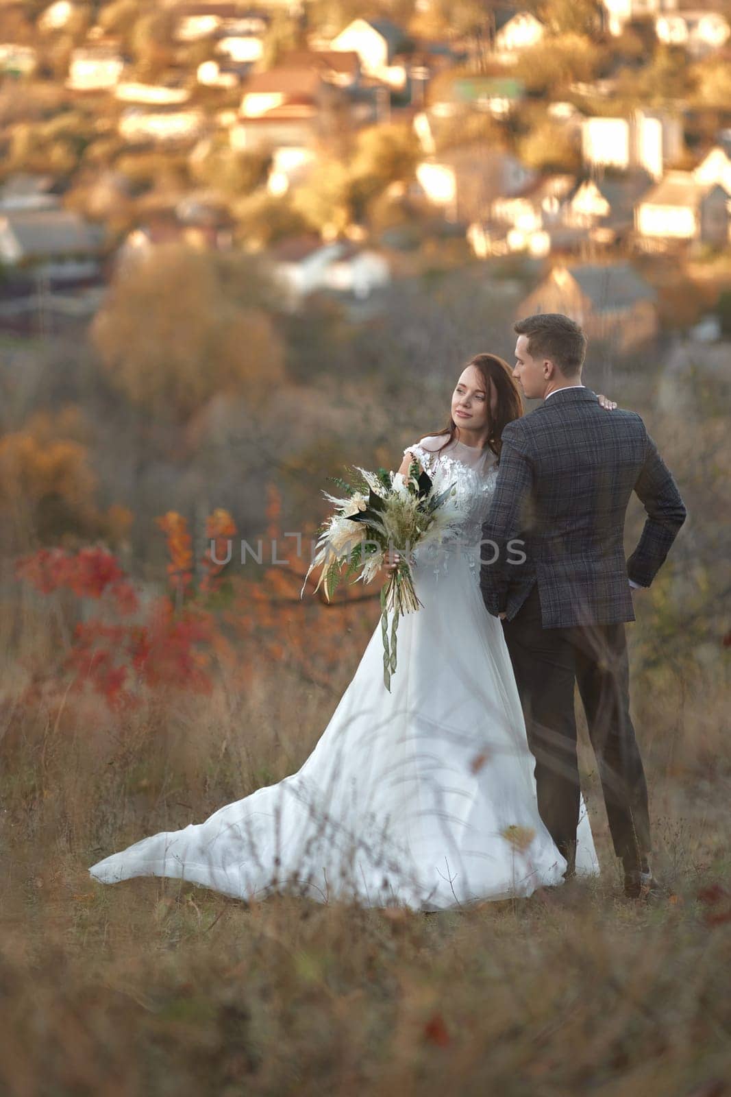 beautiful wedding couple together standing outdoor on natural background