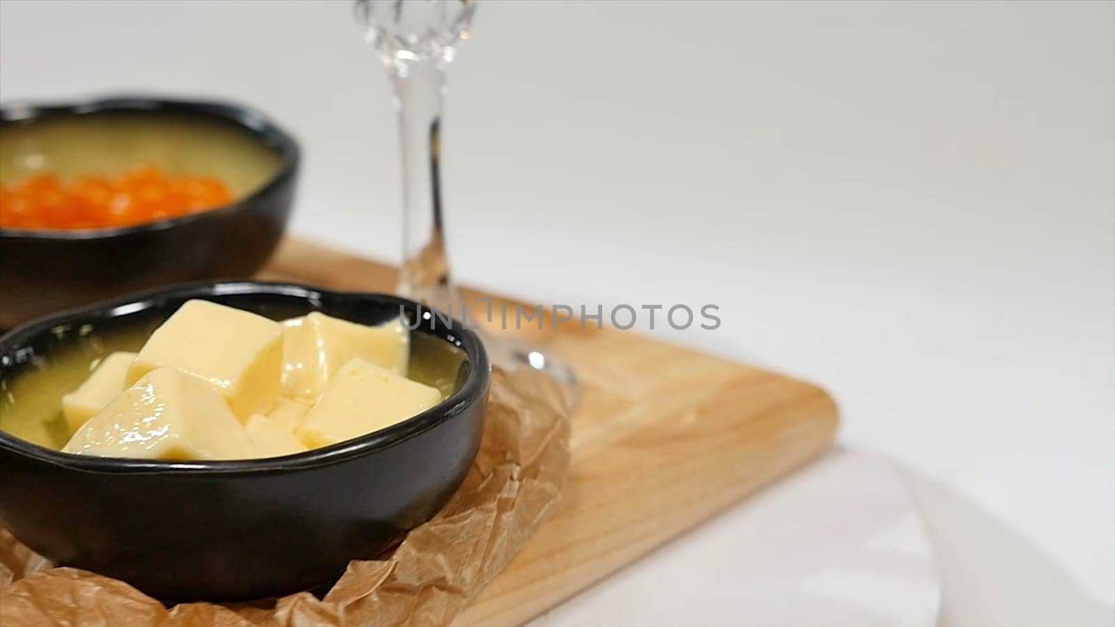 Snack, sandwiches with butter, red caviar, crispy baguette and white wine on white background. Red caviar. Lemon. Greens. Bread and butter HD