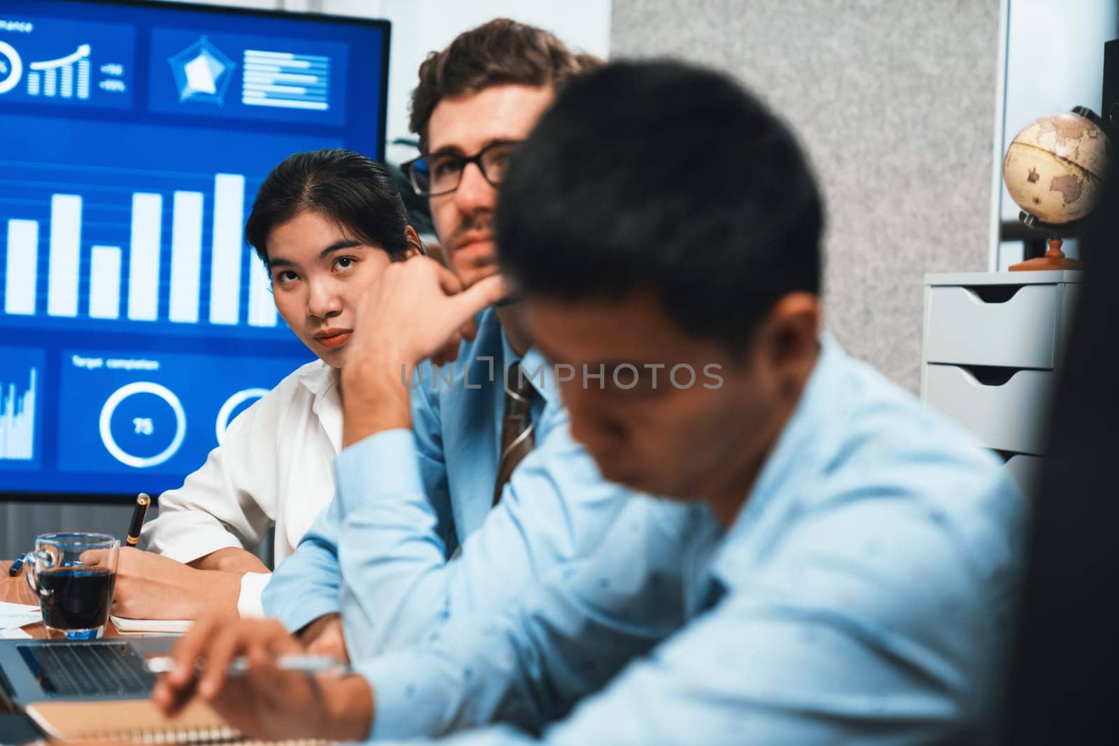 Diverse group of business analyst team analyzing financial data report. Finance data analysis chart and graph dashboard show on TV screen in meeting room for strategic marketing planning. Habiliment