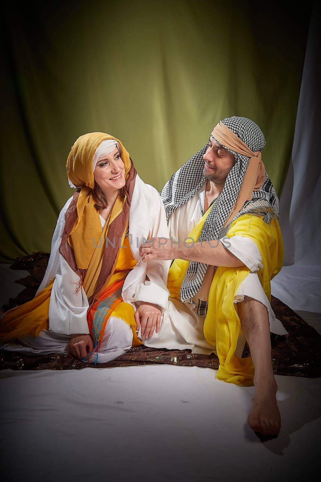 A couple in love or a married couple in stylized Eastern clothing from Israel, Palestine, Iran, Pakistan together. Tender photo session in the style of the Middle East and the Bible