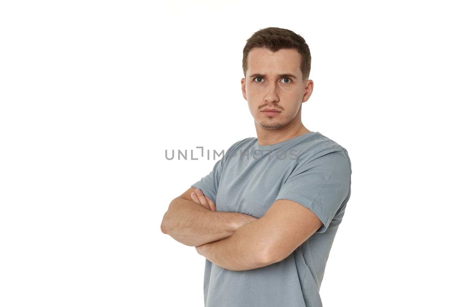 profile of man wears t-shirt holds hands crossed isolated on white background