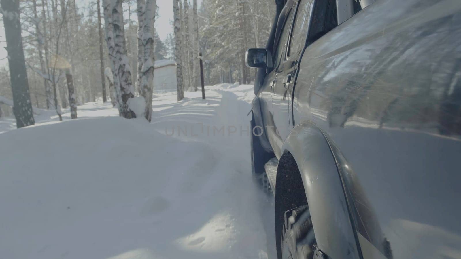 Jeep rides on the snow in the forest closeup