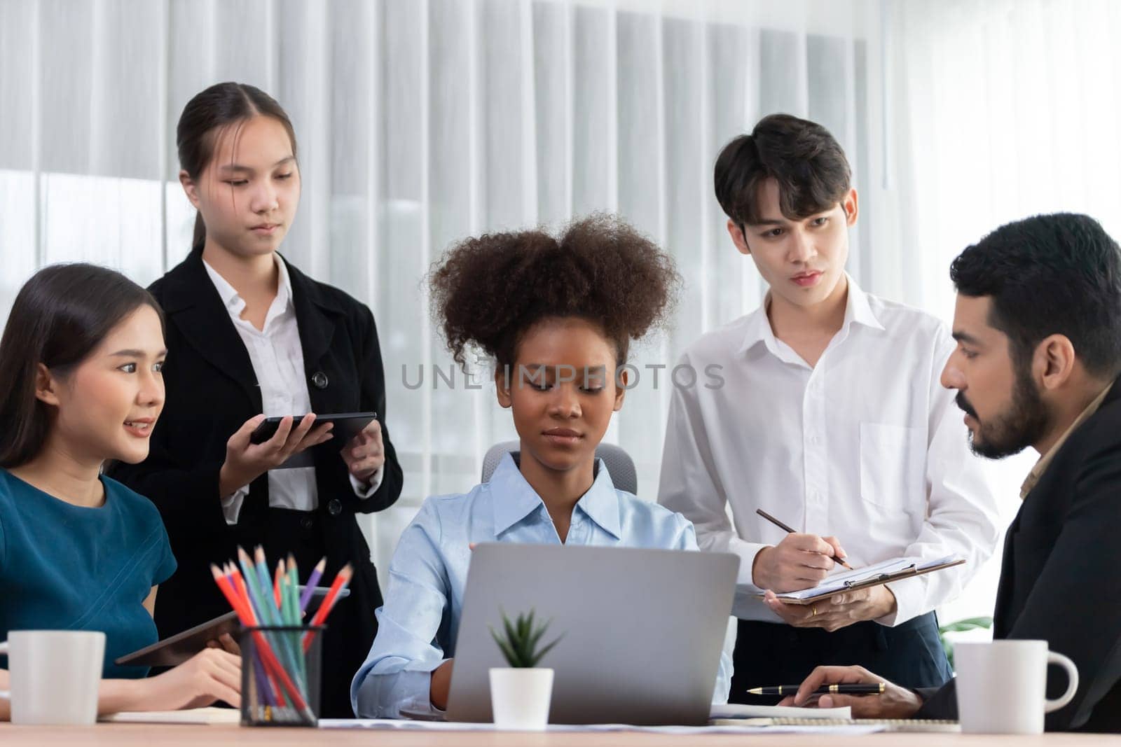 Happy diverse business people work together, discussing in corporate office. Professional and diversity teamwork discuss business plan on desk with laptop. Modern multicultural office worker. Concord