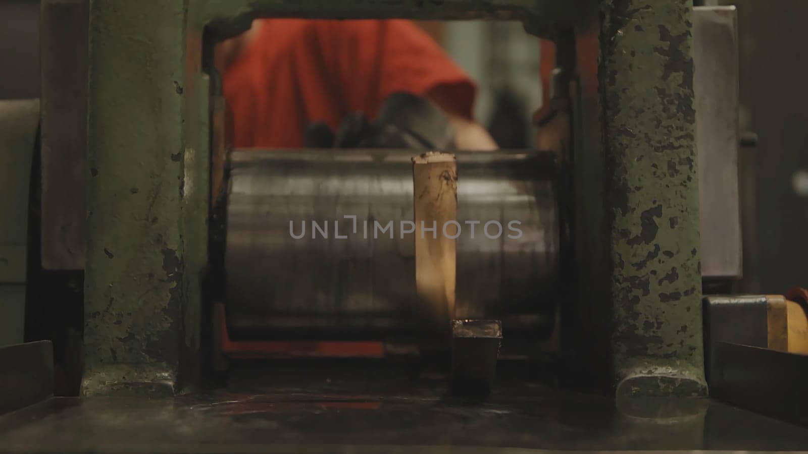 Hand-rolled gold bars. Factory worker processing roll of steel sheet. METAL INDUSTRY. Rolling mill machine for rolling steel sheet. Tilt shift effect 4K