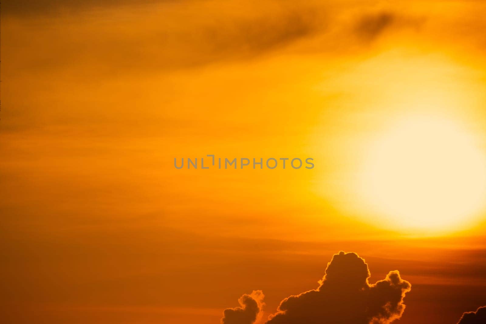 Beautiful golden sunset sky. Dramatic yellow and orange sky at sunset time. Peaceful and tranquil scene. Golden sunset sky with a majestic sun. Golden sunset sky with a big sun. Scenic Landscape.
