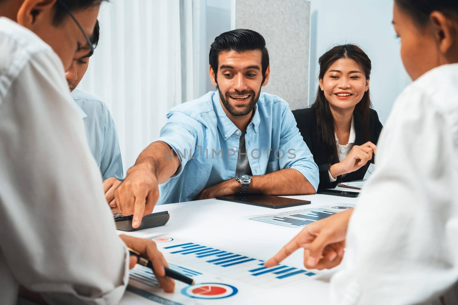 Analyst team utilizing BI Fintech to analyze financial data at table in meeting room. Businesspeople analyzing BI dashboard power on paper for business insight and strategic marketing planning.Prudent