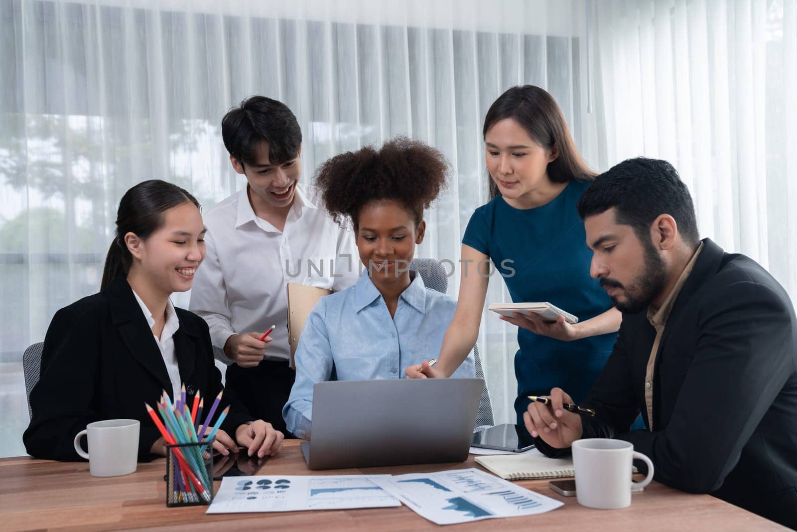 Multiracial analyst team use BI dashboard data to analyze financial report on meeting table. Group of diverse business people utilize data analysis by FIntech for success business marketing. Concord