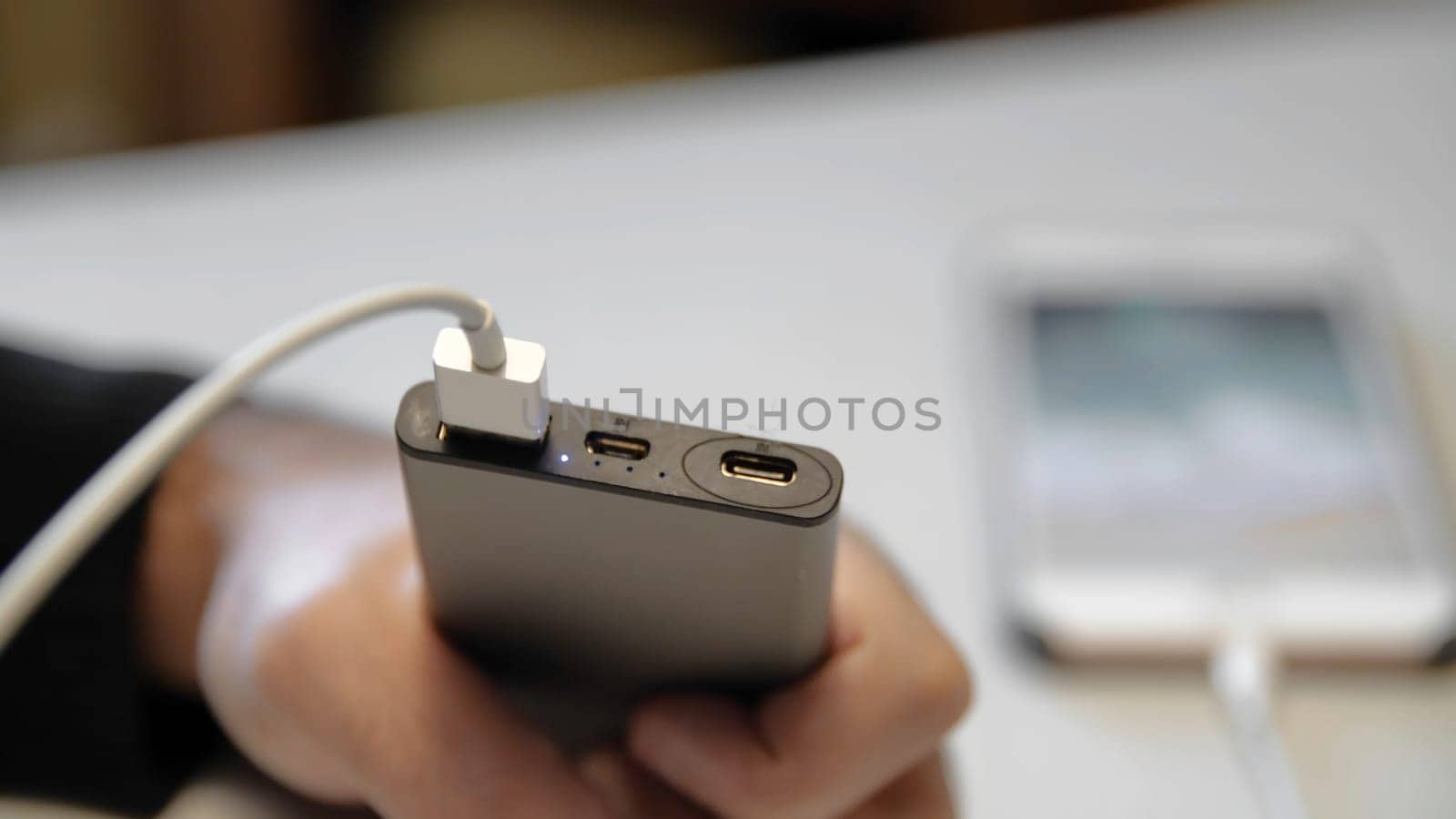 Close-up of connecting charging to your phone. Media. Special charging connector for branded phone. Charging your phone via wire.