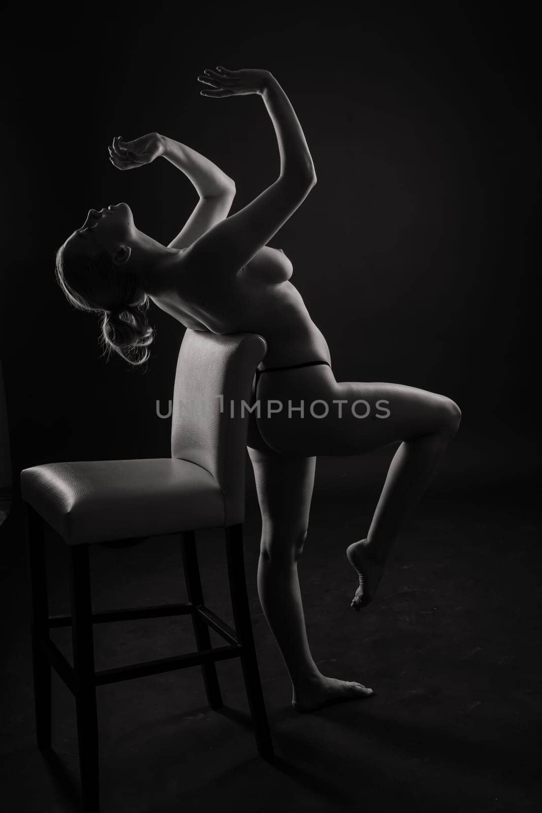 Low key portrait of beautiful female body on dark background by Zelenin