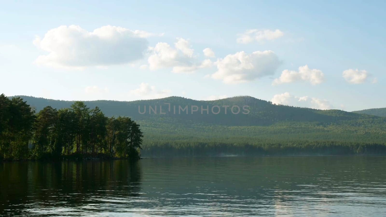 Summer landscape with river, cloudy sky, forest and sun timelapse. summer landscape with river and blue sky time lapse. Amazing clouds on the lake coast.