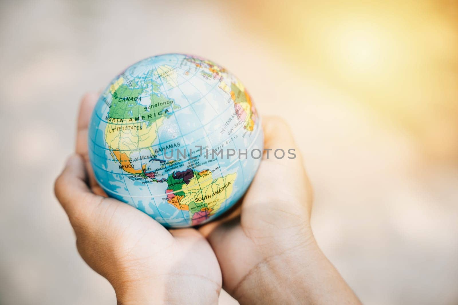 Celebrate World Earth Day with the concept of Green Energy, ESG, and Environmental Care. Hold the globe and a green leaf to symbolize responsibility and global support for our environment. by Sorapop