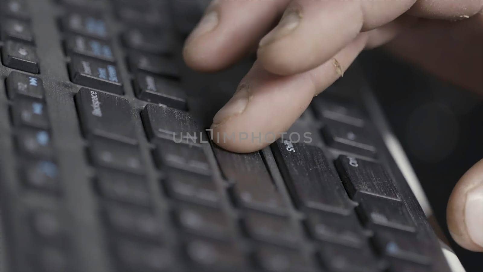 Close-up of finger over black laptop keys pressing enter button, computers and technologies concept. Man finger pushing enter key on black laptop keyboard.