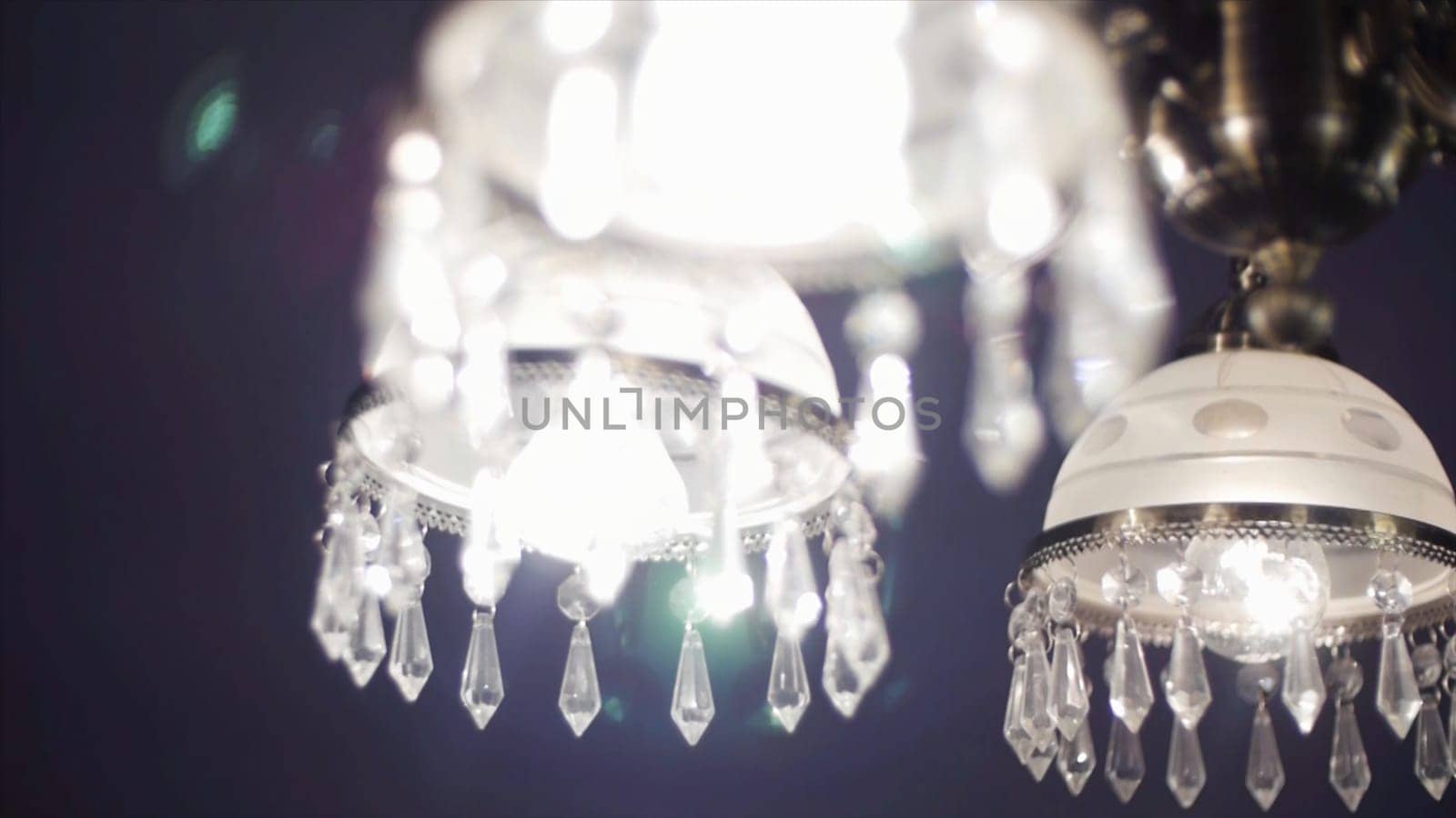 Chrystal chandelier close up, selective focus. Chrystal chandelier close-up. Crystal chandelier close-up. Glamour background with copy space.