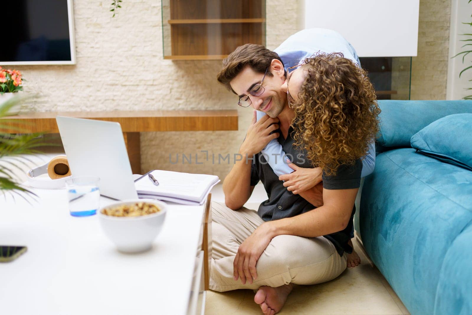 Delighted woman hugging happy partner at home by javiindy