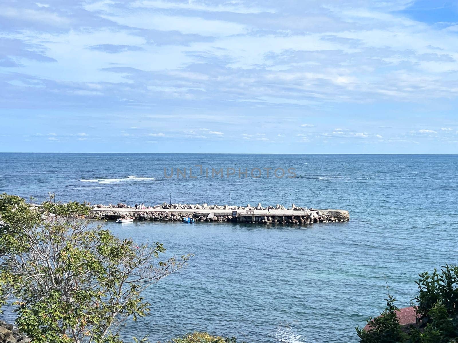 Beautiful view of stone barrier for blocking the sea waves. High quality photo