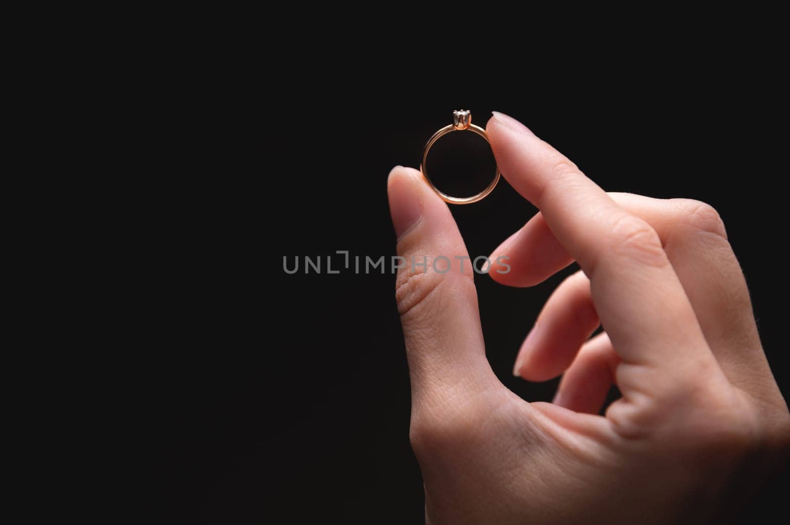ring is held with the fingers, demonstrating the diameter of the ring and its type. jewelry in a woman's hand by yanik88