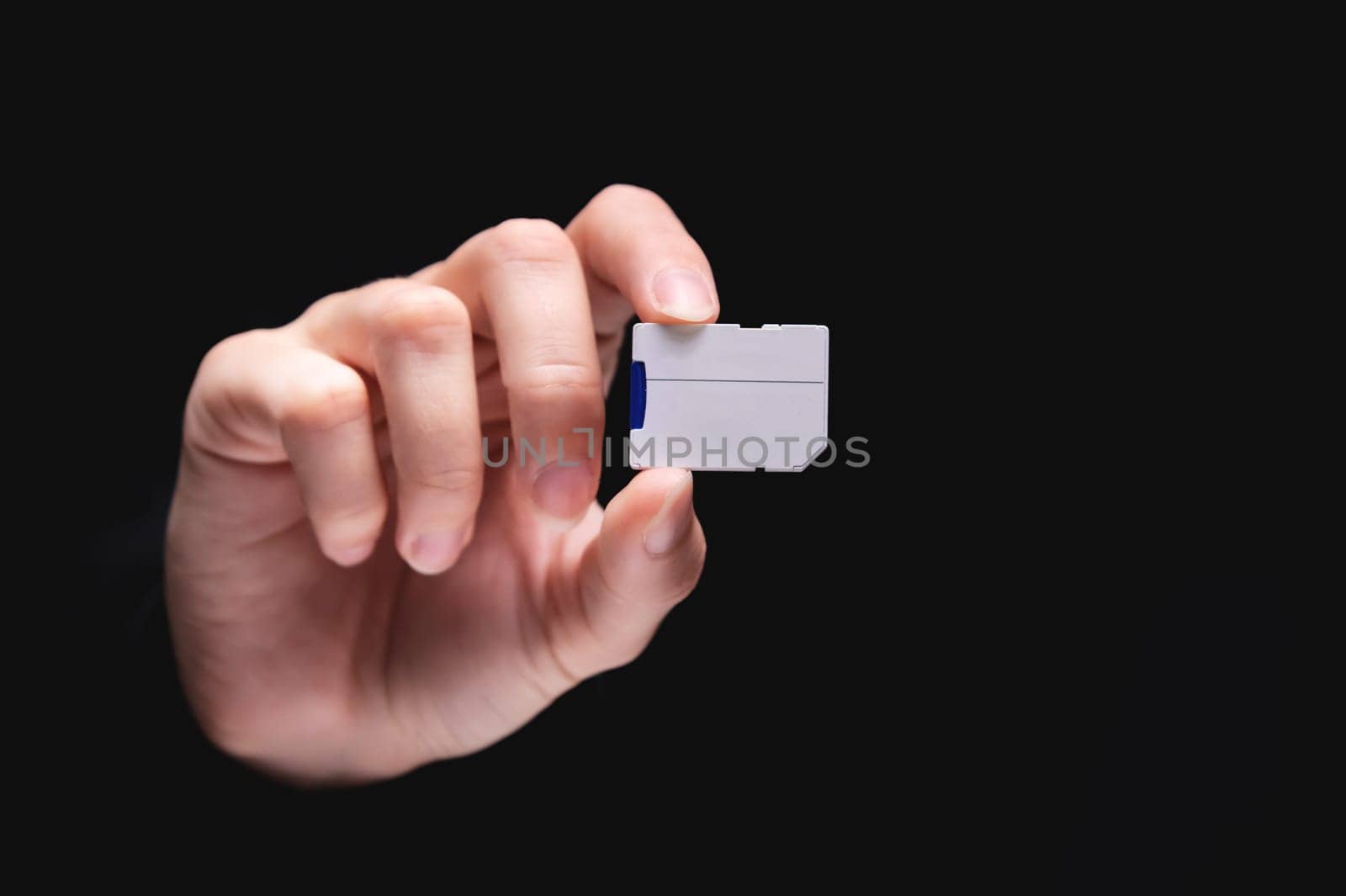 Micro SD memory card adapter on background. front view close up adapter in hand.