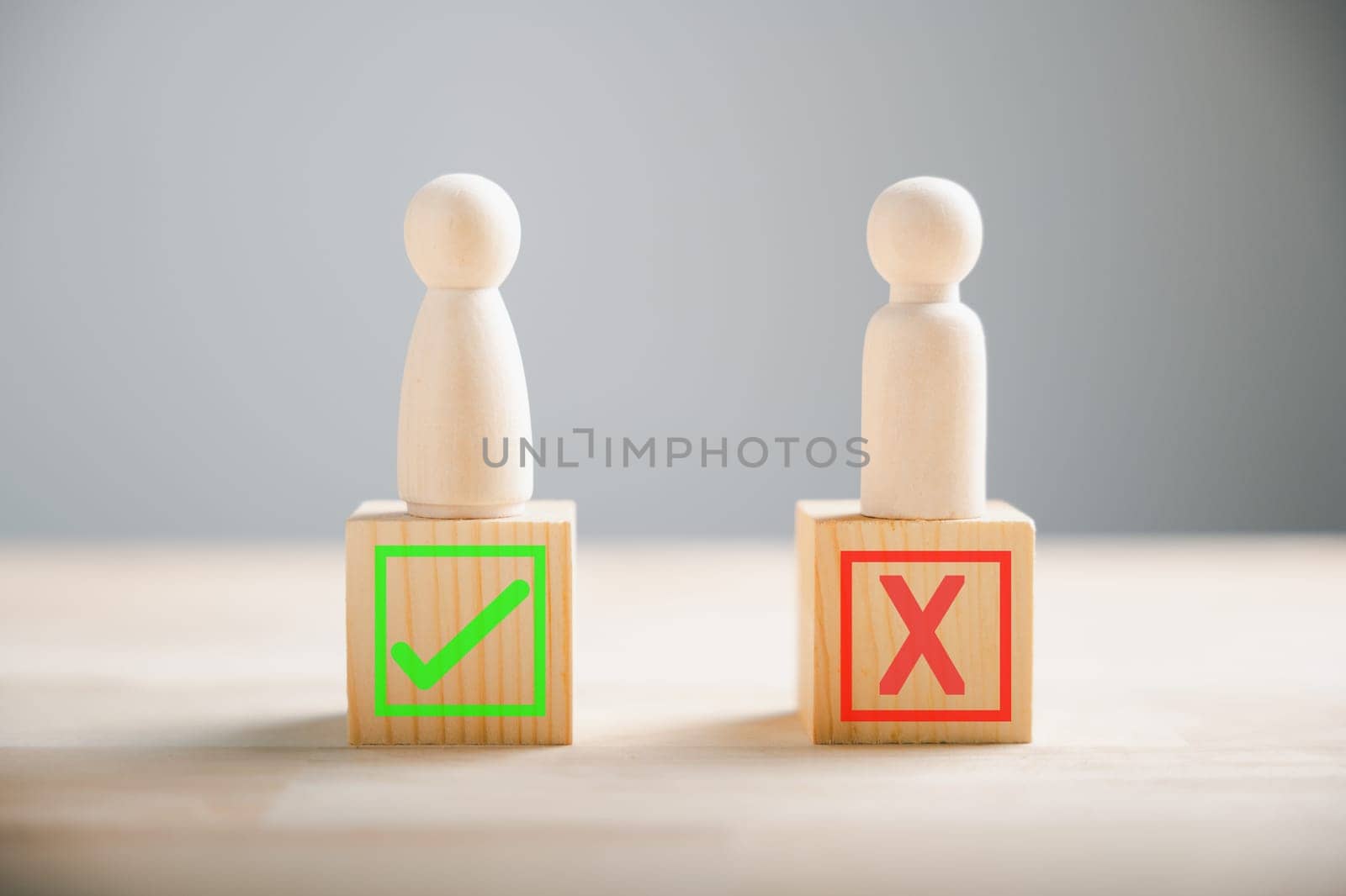 People demonstrate right and wrong on wooden blocks contemplating yes or no. Business dilemma shown with true and false symbols. Decision-making concept on wood. Think With Yes Or No Choice.