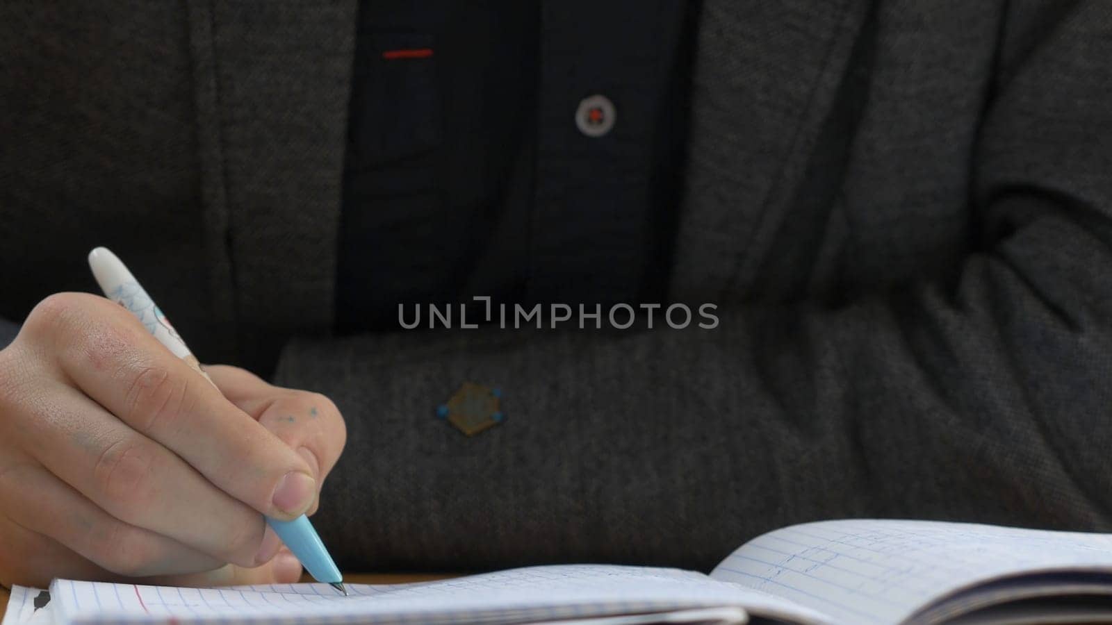 Student writes in the exercise book. Student writes a lecture.