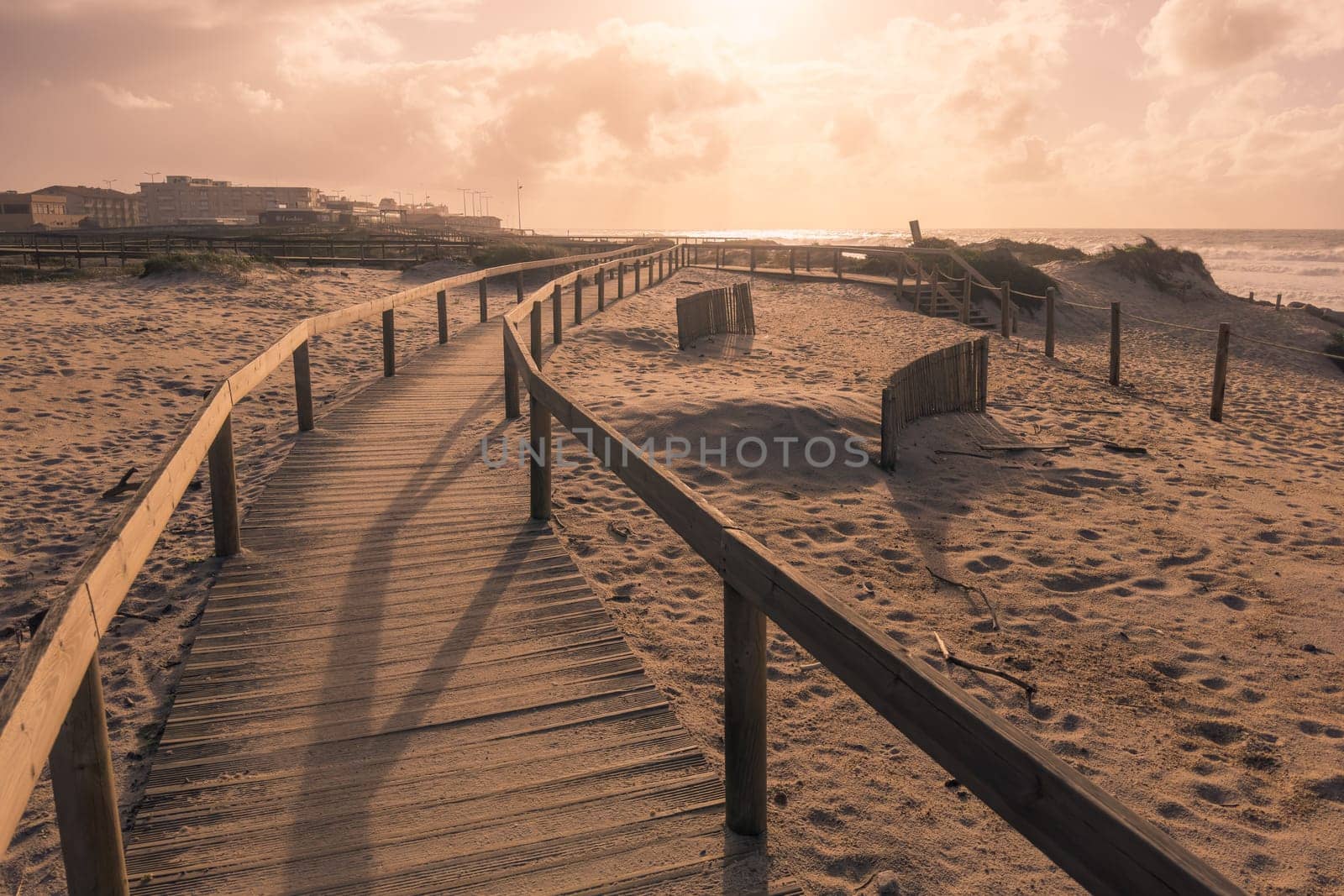 Wooden pathway leading to the beach on the throught the sand dunes at Furadouro - Ovar, Portugal.