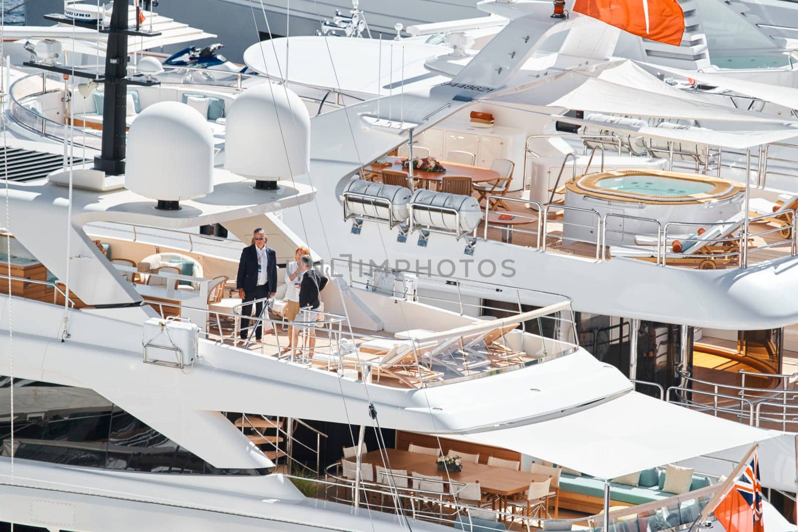 Monaco, Monte Carlo, 27 September 2022 - Invited wealthy clients inspect megayachts at the largest fair exhibition in the world yacht show MYS, port Hercules, yacht brokers, sunny weather. High quality photo