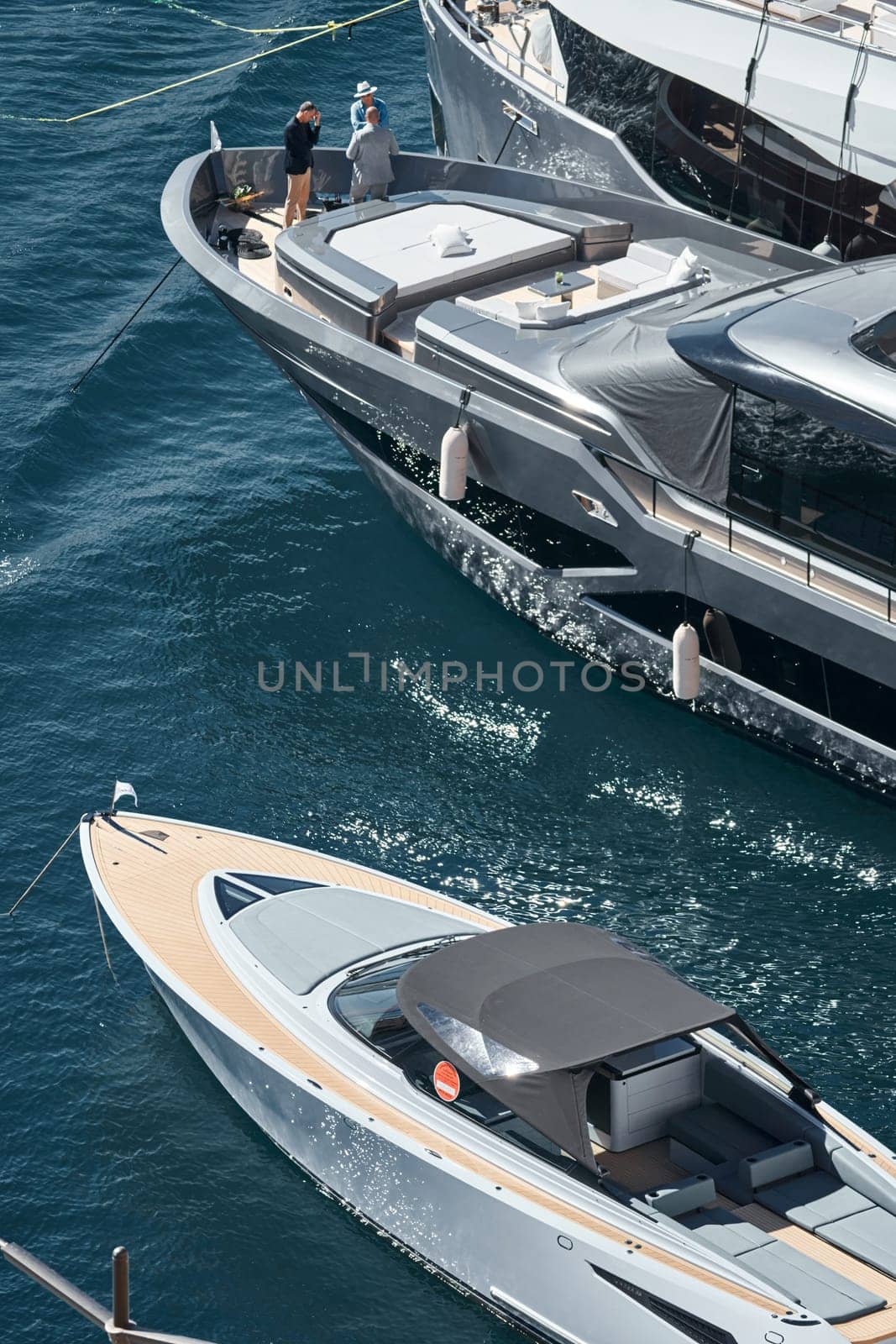 Monaco, Monte Carlo, 27 September 2022 - Invited wealthy clients inspect megayachts at the largest fair exhibition in the world yacht show MYS, port Hercules, yacht brokers, sunny weather. High quality photo