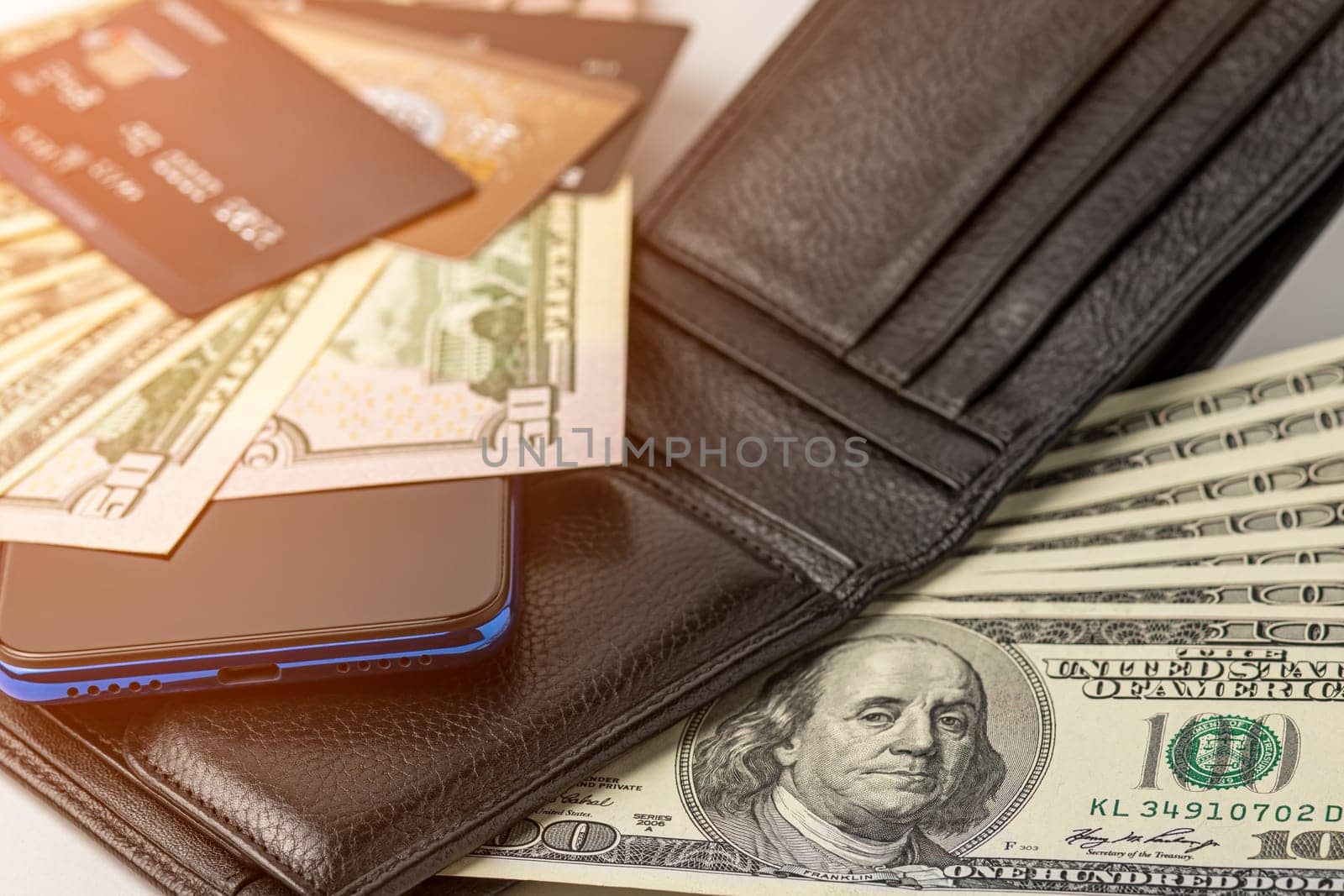 Phone, wallet with money and credit cards, close-up. by Yurii73