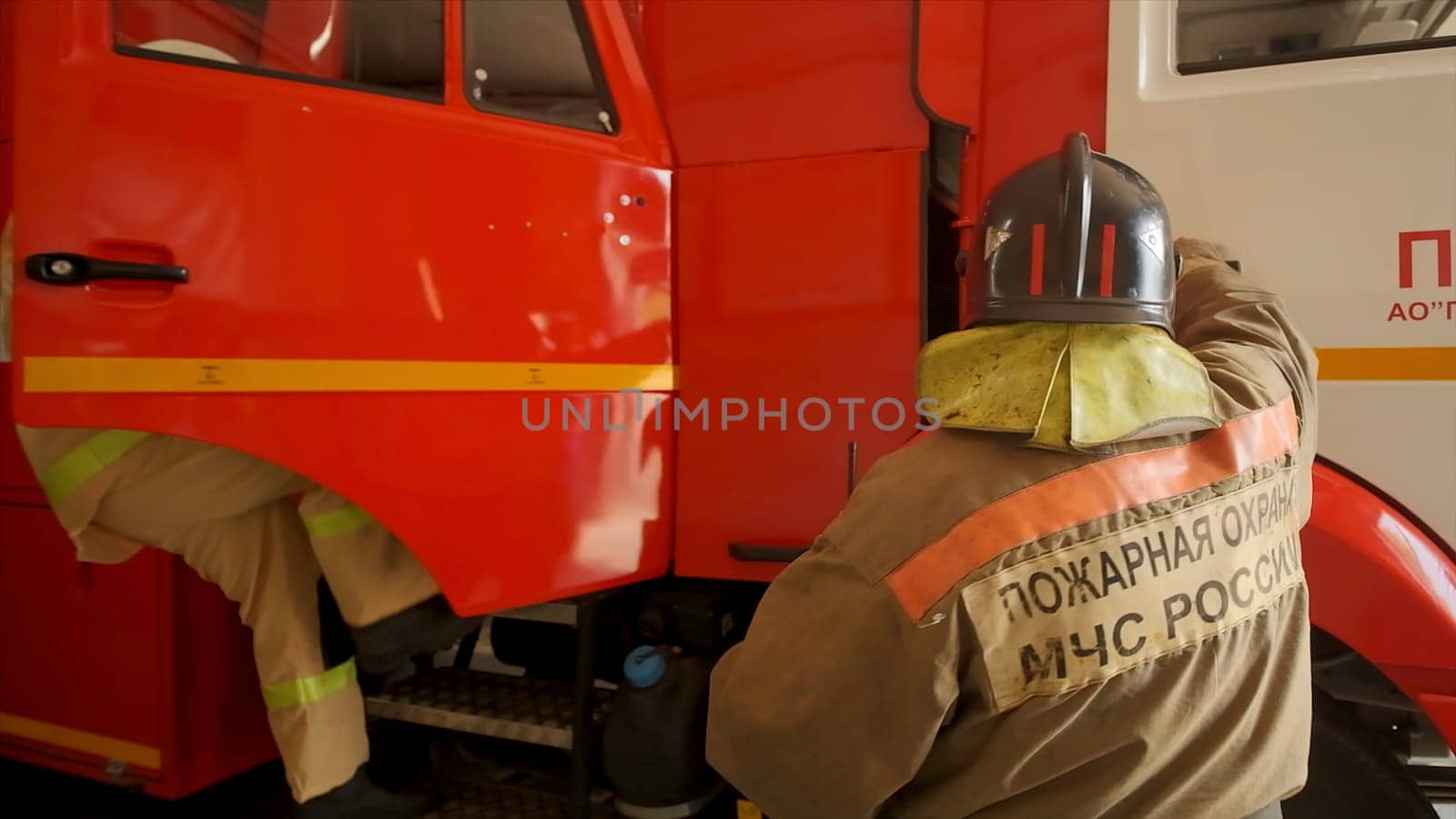 Firefighters climb into car. Clip. Firefighters get into car and go to call. Firefighters are getting ready and going out on call.