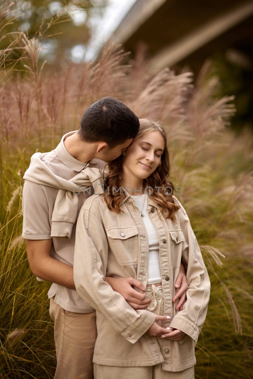 Young Cute Female Hugs Boyfriend. In Autumn Outdoor. Lovers Walking in Park. Attractive Funny Couple. Lovestory in Forest. Man and Woman. Cute Lovers in the Park. Family Concept. Happy Couple.