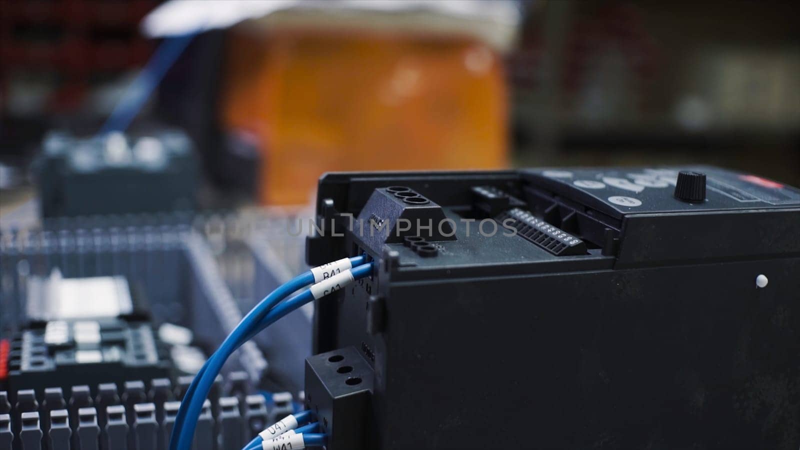 Close-up of charging electric battery with wires. Clip. Black battery box for large electrical equipment is on charge. Electric battery with connected wires is on charge.