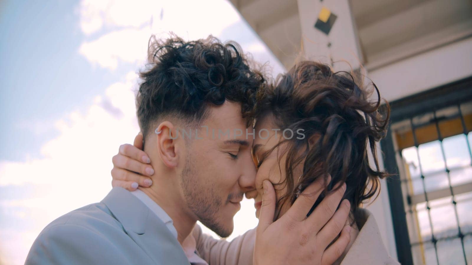 Couple in love relaxing on the yacht and enjoying picturesque view and each other. Action. Man and woman hugging each other during their trip on yacht