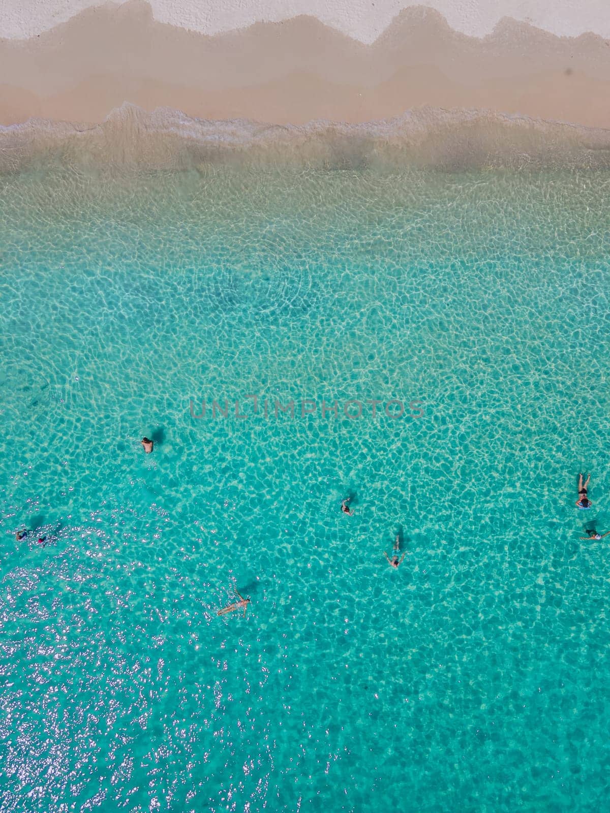 people swimming in the ocean of Koh Samet Island Thailand during vacation, aerial drone view from above at the Samed Island in Thailand with a turqouse colored from above