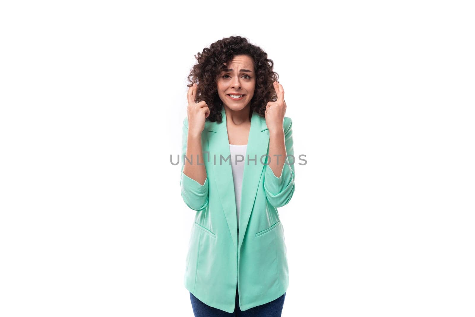 pretty young brunette curly businesswoman dressed in a blue jacket tells interesting news by TRMK