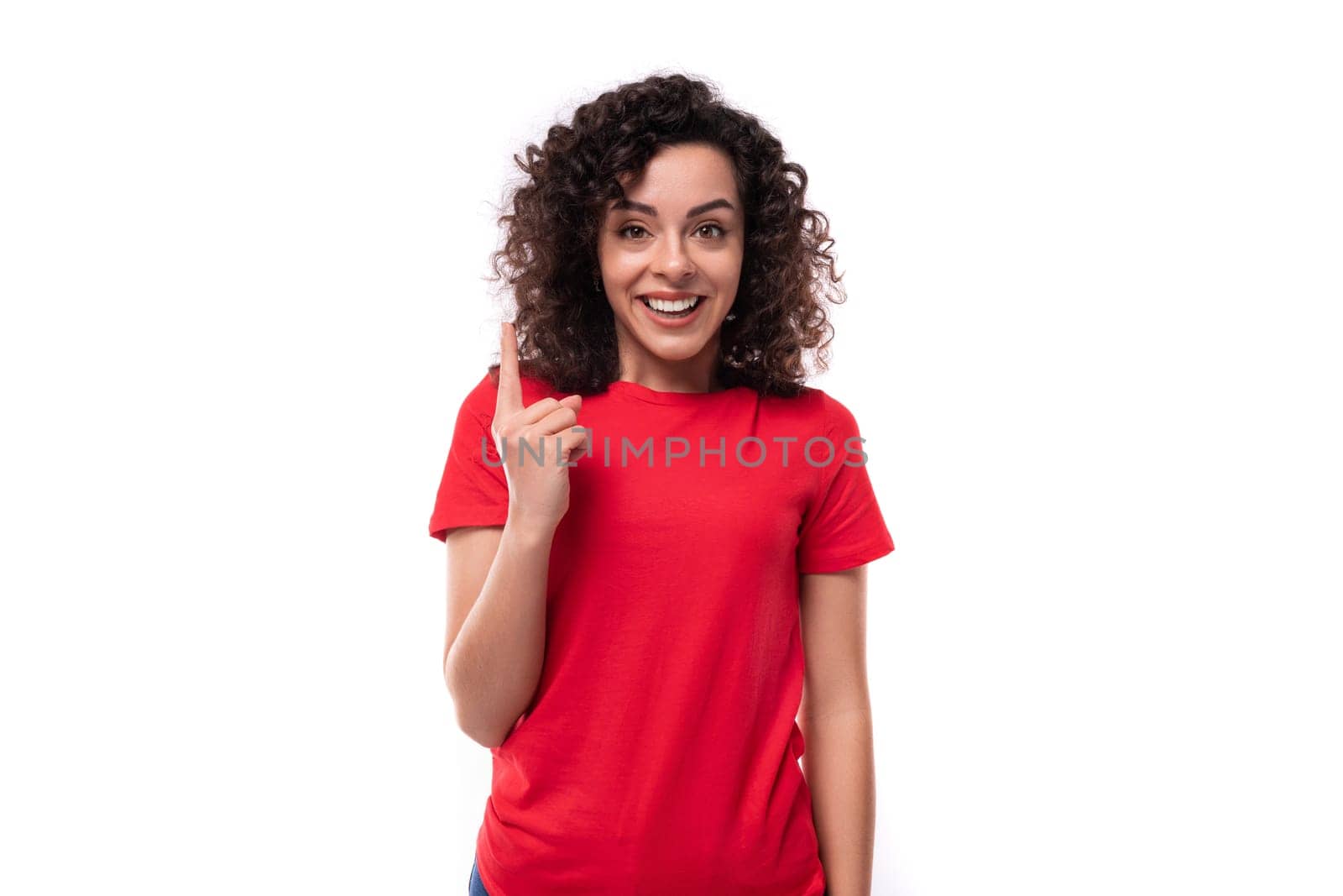 caucasian young energetic curly brunette woman in red casual t-shirt.