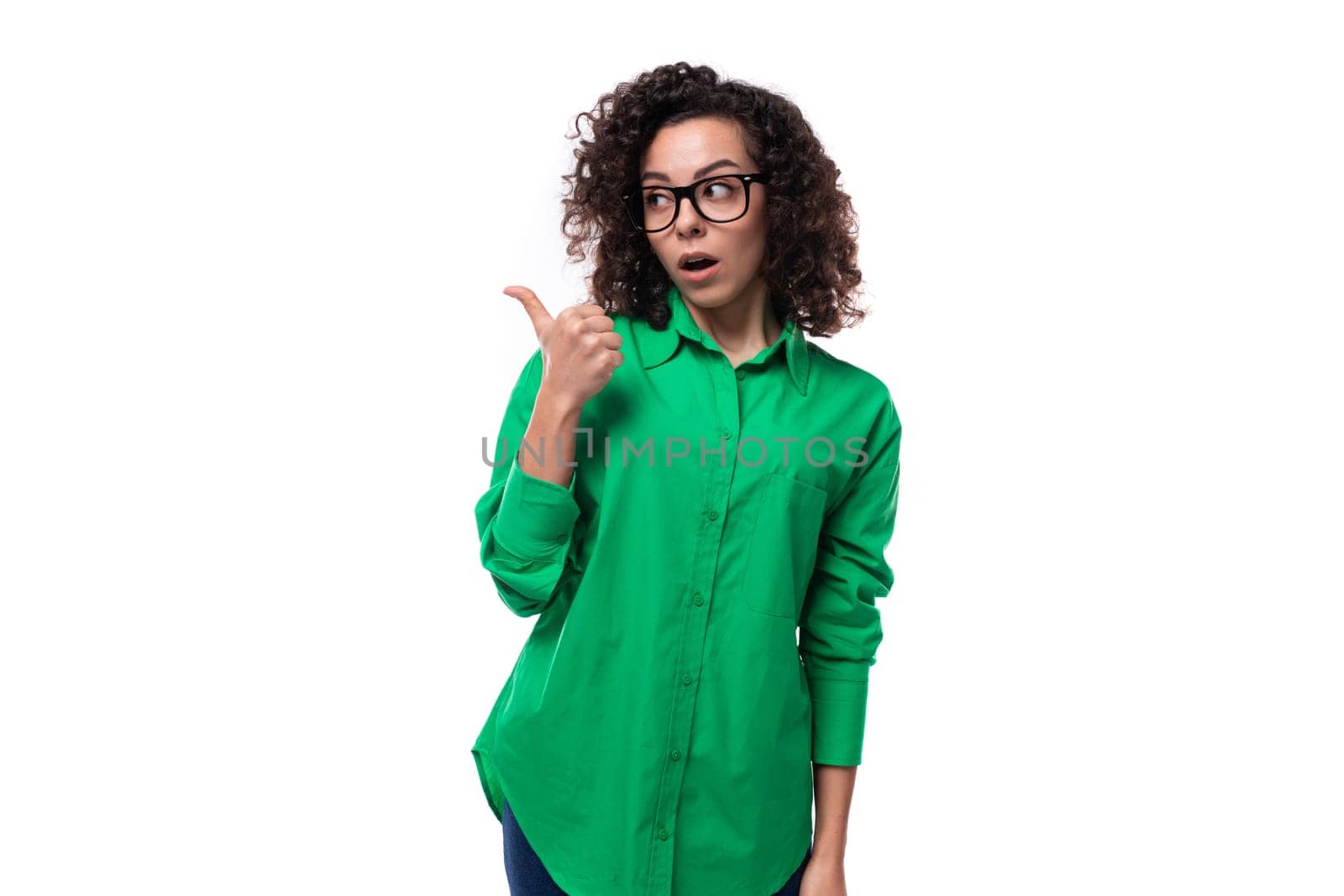 portrait of a brunette young caucasian lady with curly hair dressed in a green shirt.