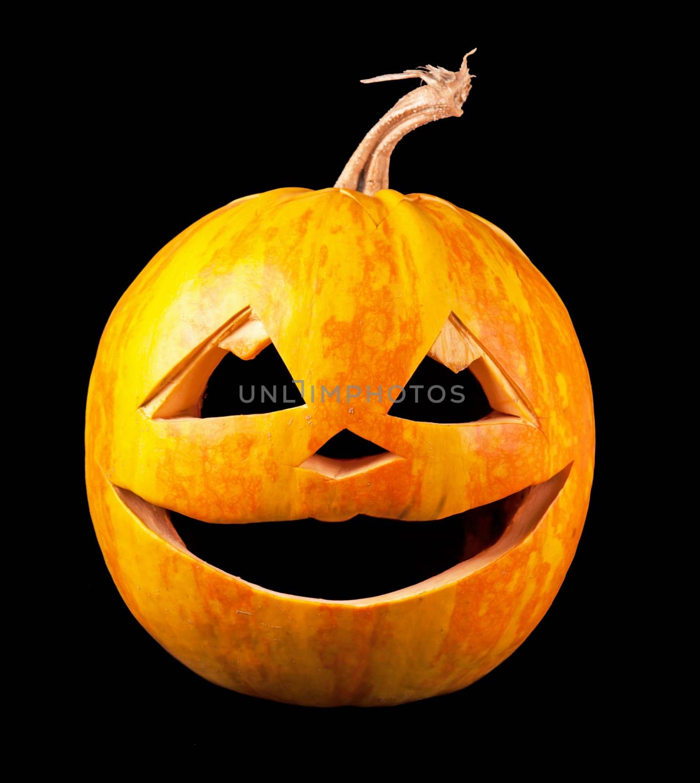 Scary Halloween pumpkin isolated on a black background. Scary glowing face trick or treat by aprilphoto