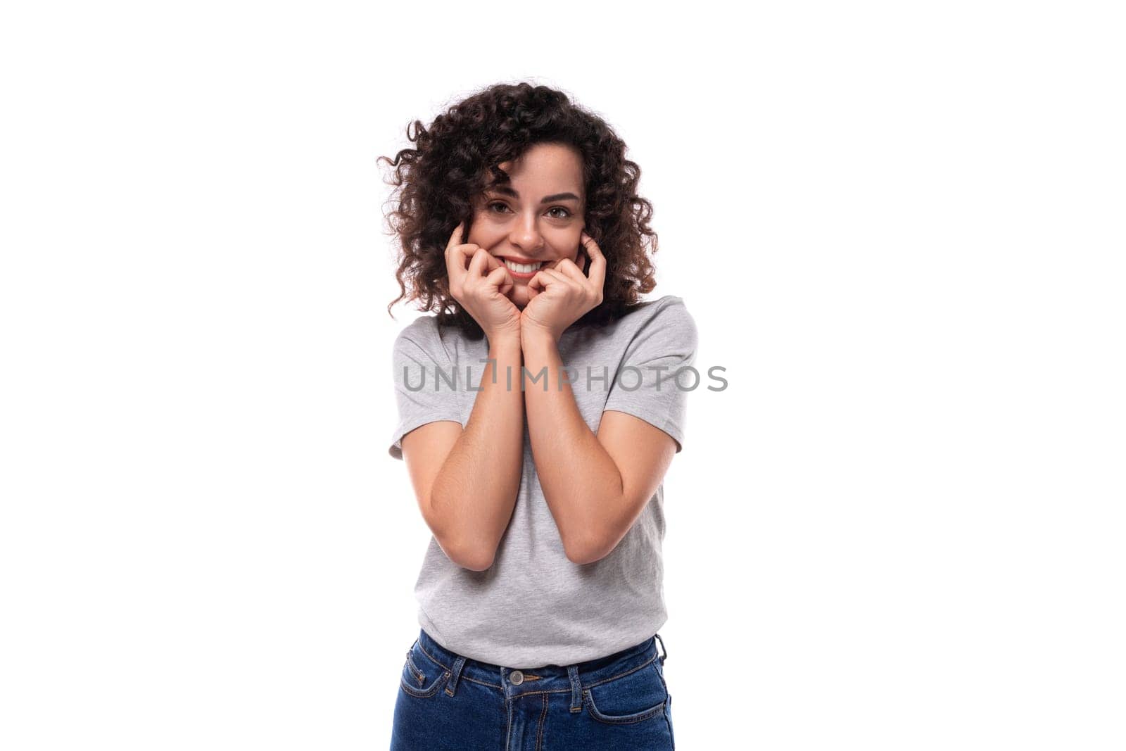 young slender brunette curly woman is dressed in a gray basic corporate color t-shirt. clothing identity and branding concept by TRMK