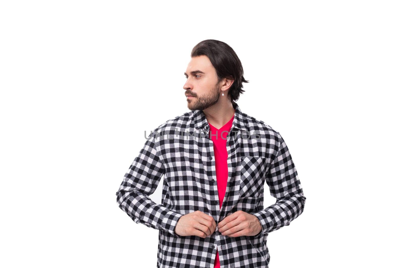 young brutal bearded brunette man in a shirt on a white background with copy space.
