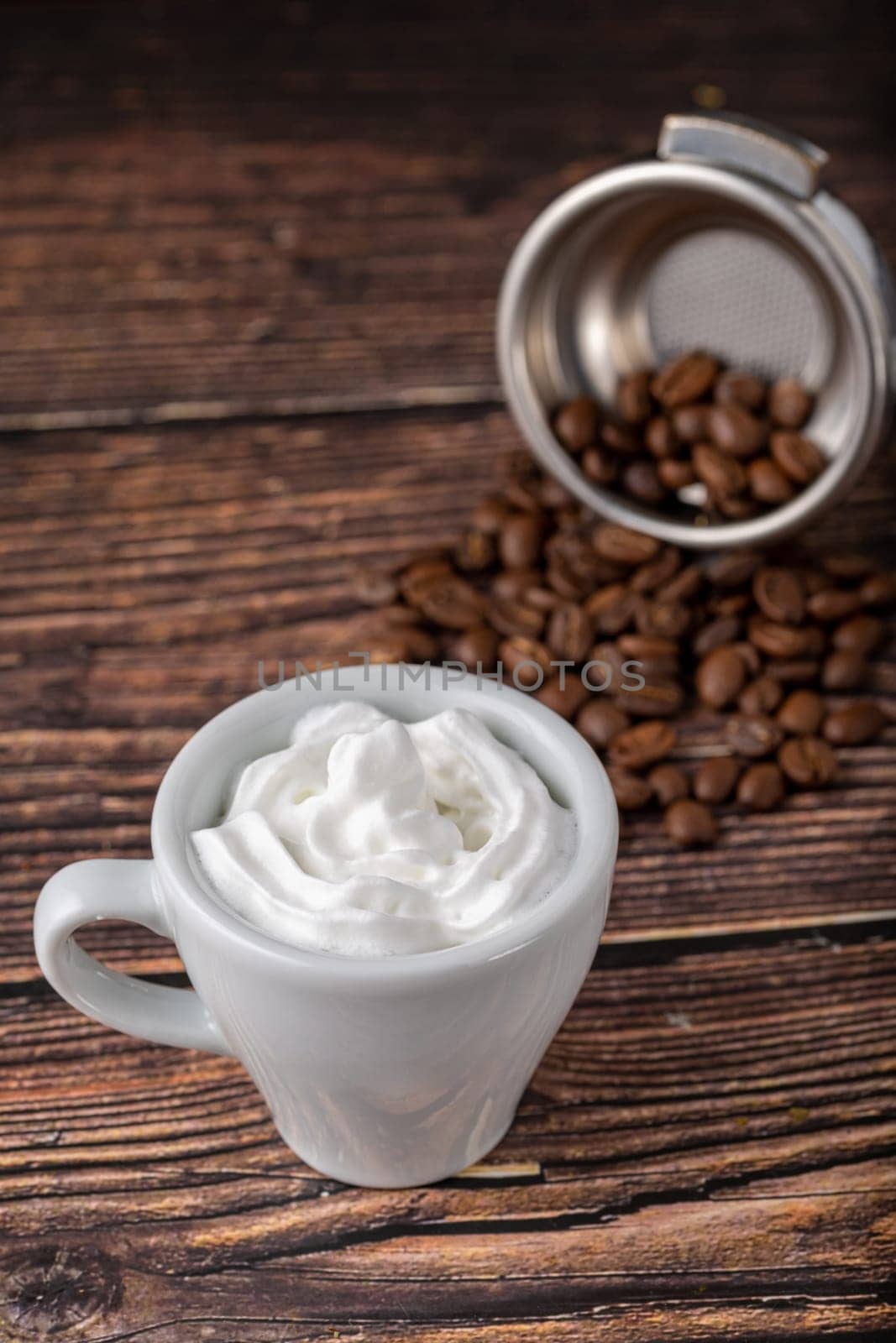 Espresso con panna in white porcelain cup on wooden table