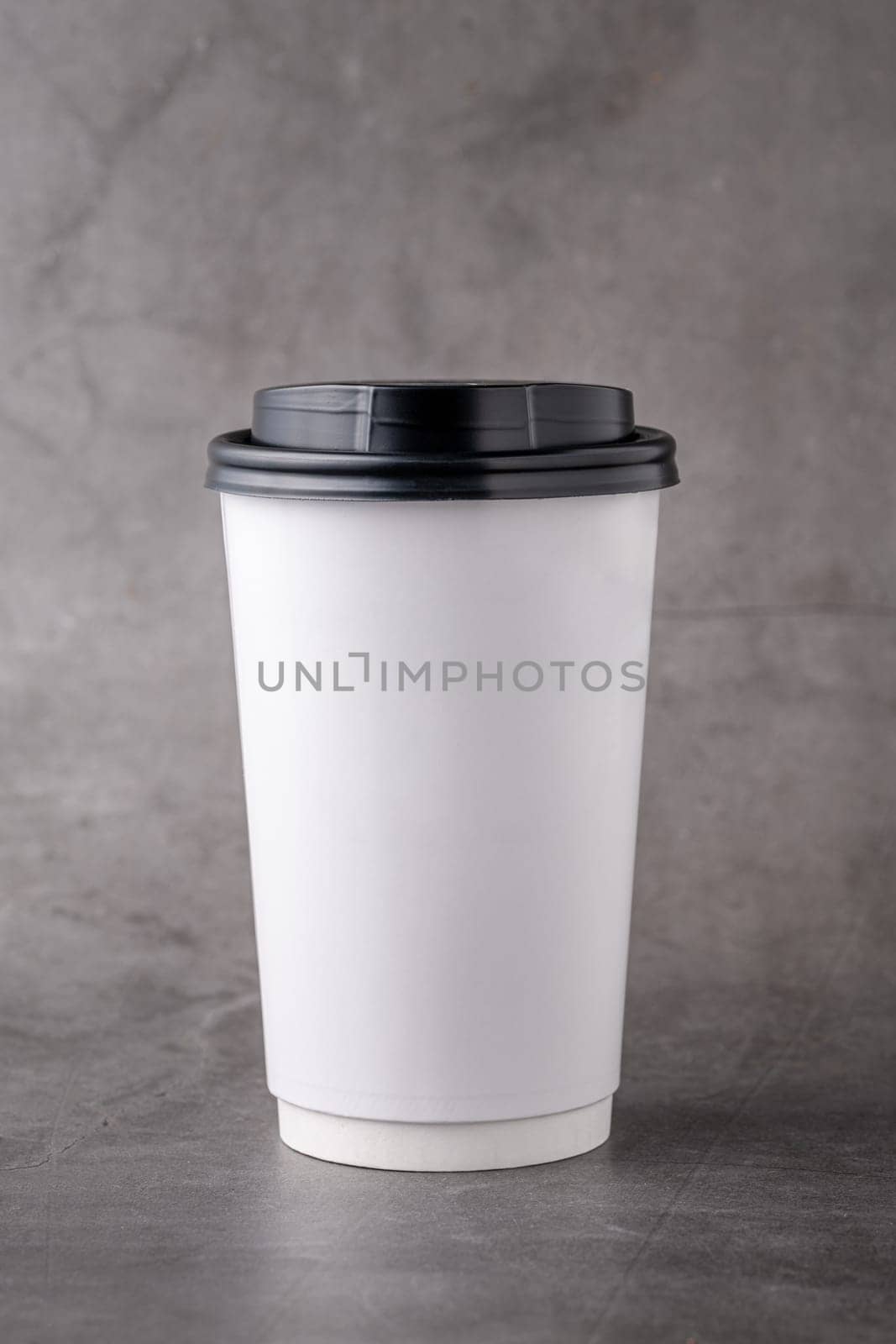 White takeaway paper cup with black plastic lids isolated on gray background