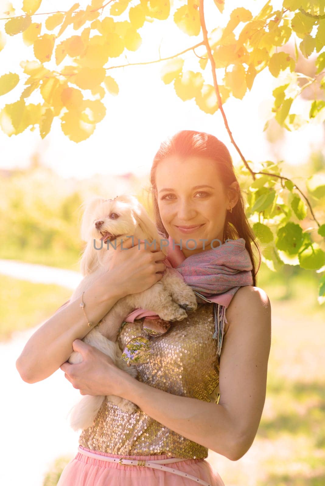 Young woman with her dog. Puppy white dog with it's owner. Concept about friendship, animal and freedom.