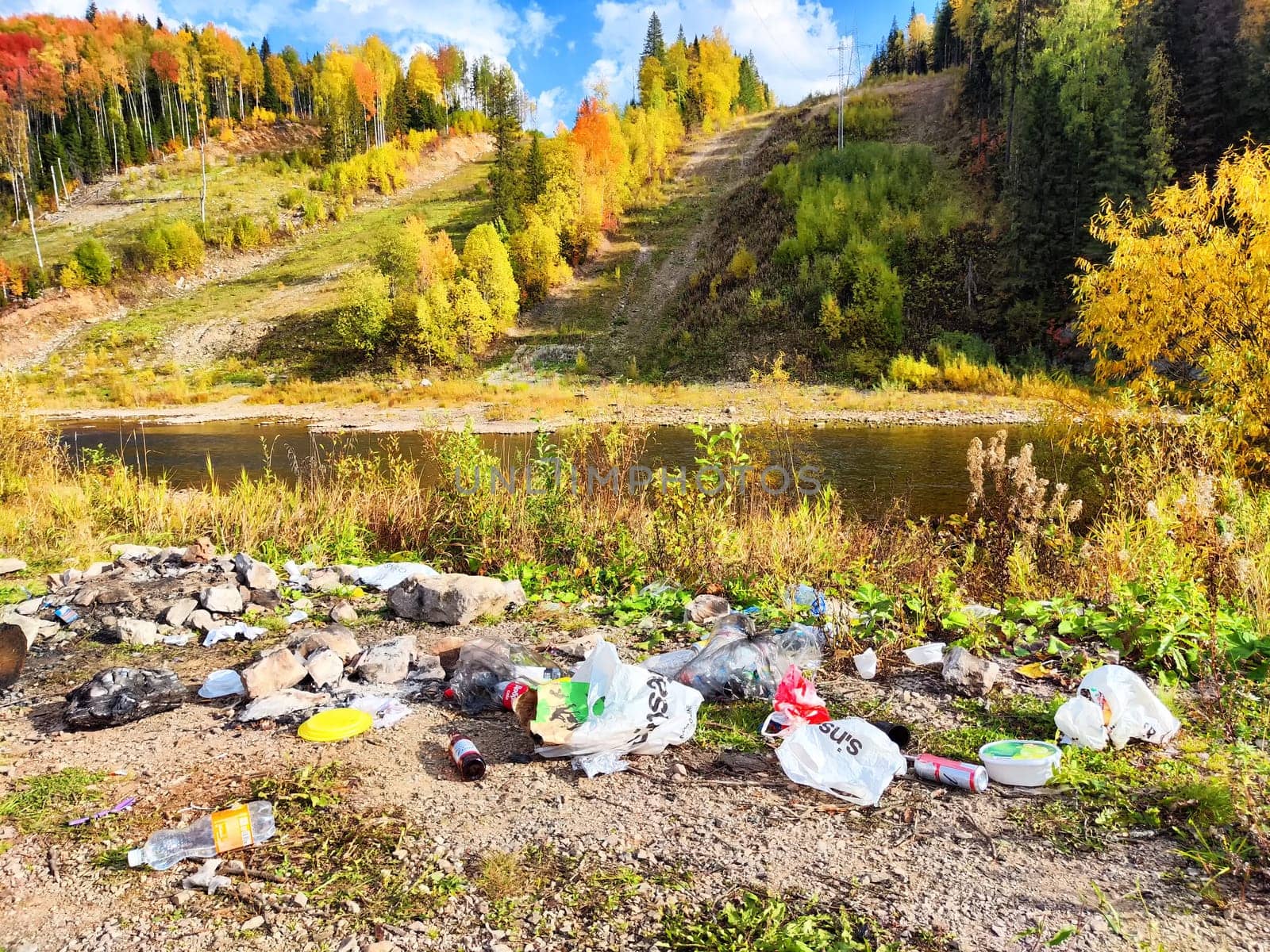 Perm, Russia - September 18, 2023: Pile of garbage left in the beautiful nature. Human damage to the environment. Concept of environmental pollution. Environmental Disaster