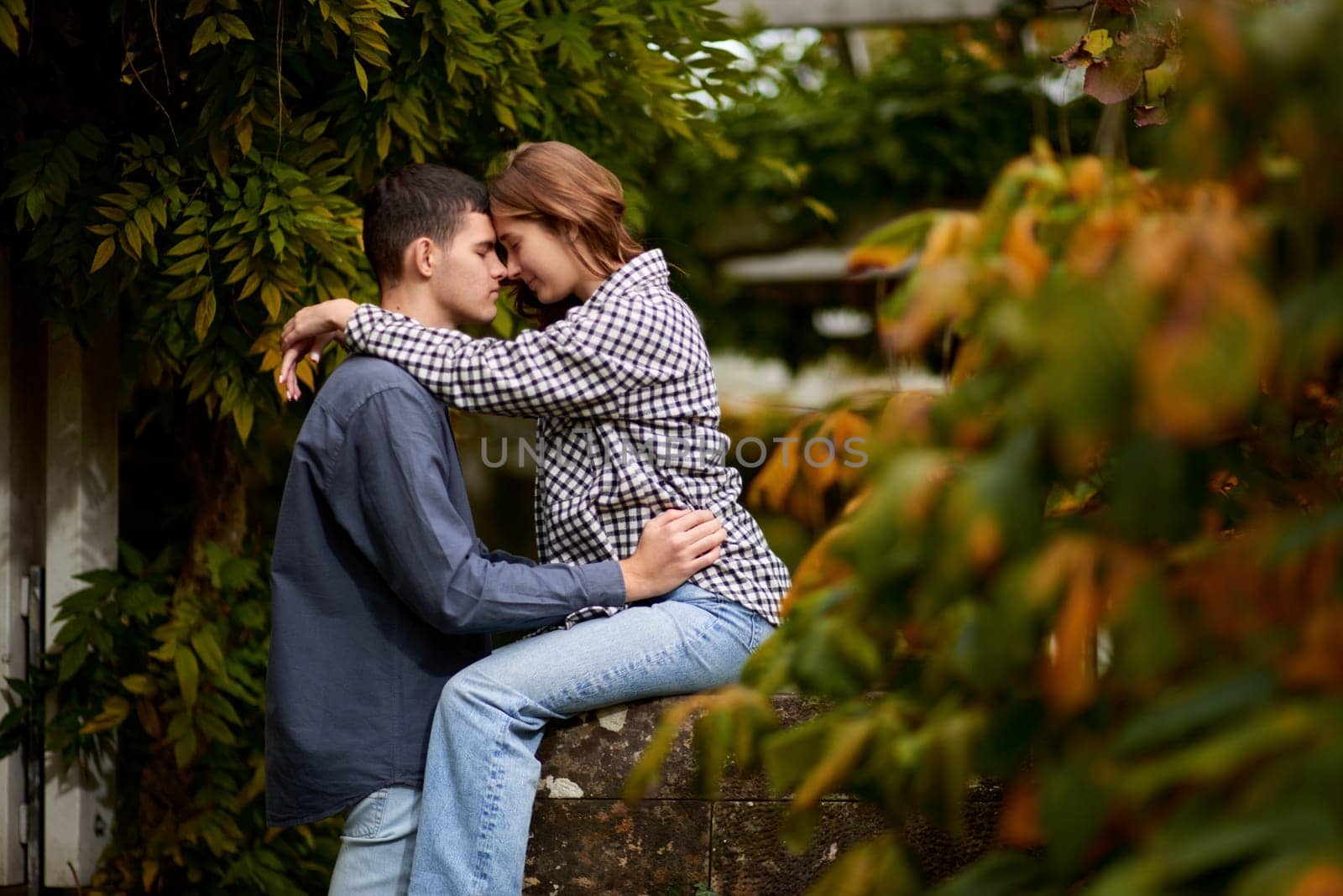 Young Cute Female Hugs Boyfriend. In Autumn Outdoor. Lovers Walking in Park. Attractive Funny Couple. Lovestory in Forest. Man and Woman. Cute Lovers in the Park. Family Concept. Happy Couple.