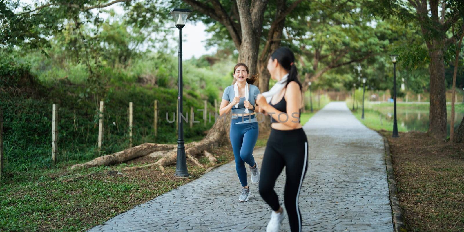 Healthy and active lifestyle, sport concept. Attractive ecstatic young sportswoman, smiling joyfully as jogging, sprinter run in park by nateemee