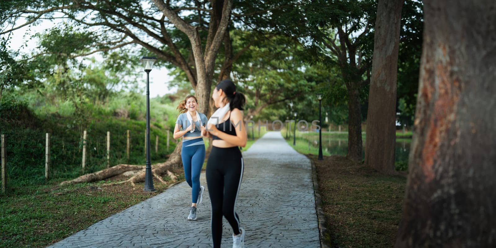 Healthy and active lifestyle, sport concept. Attractive ecstatic young sportswoman, smiling joyfully as jogging, sprinter run in park.