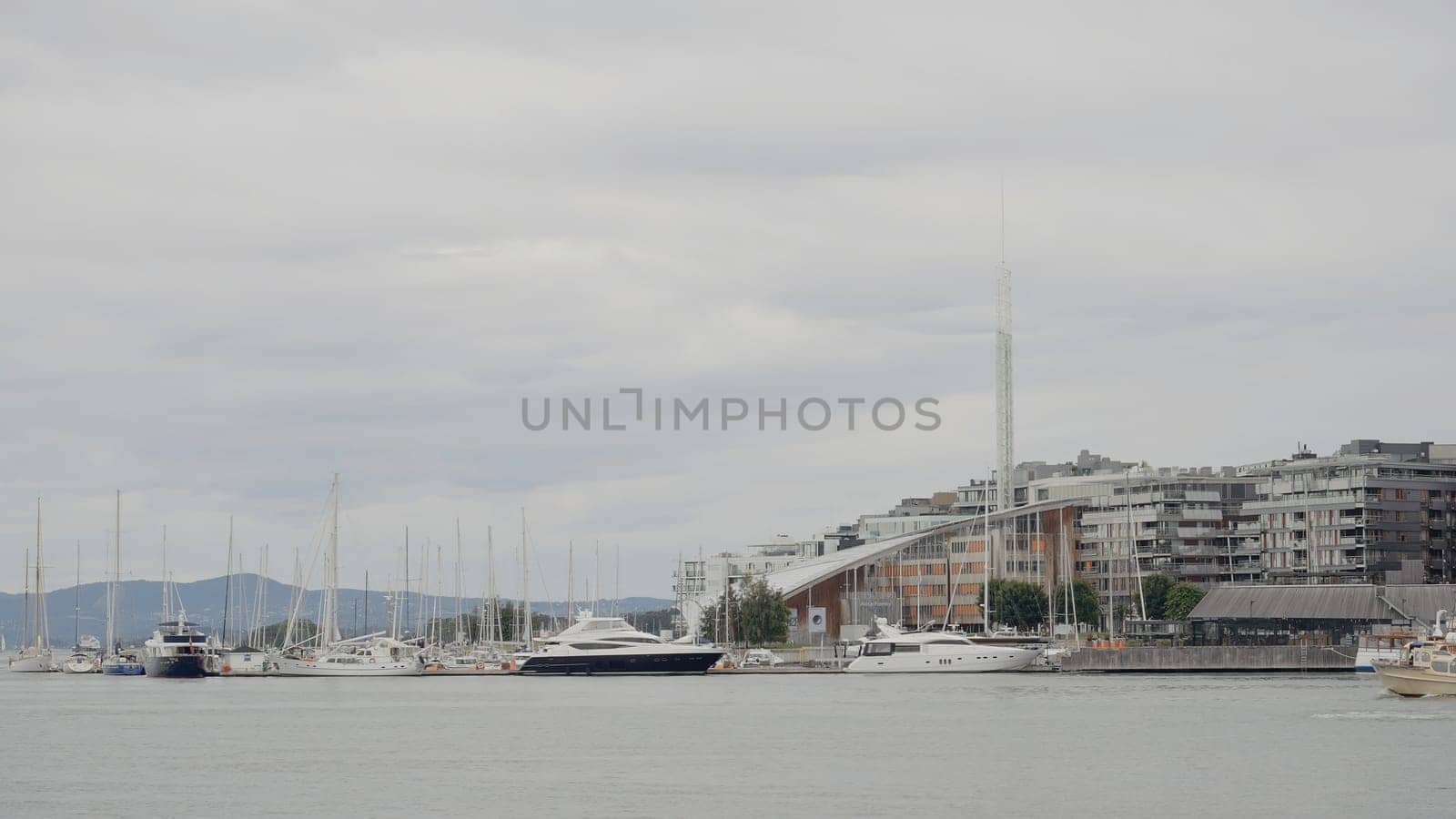 Landscape of the river. Action.A blue river with parked ships and buildings on the shore and the blue sky is visible. High quality 4k footage