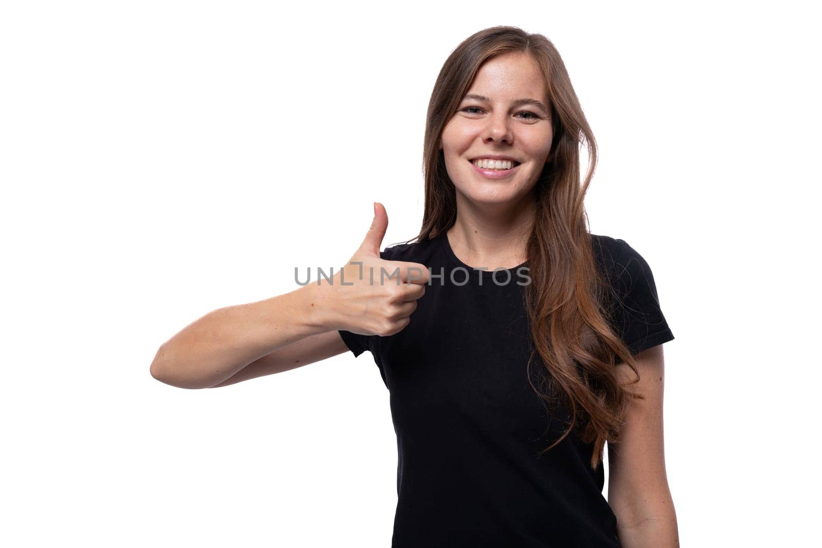 Caucasian brown-haired woman communicates an idea and holds a thumbs up by TRMK