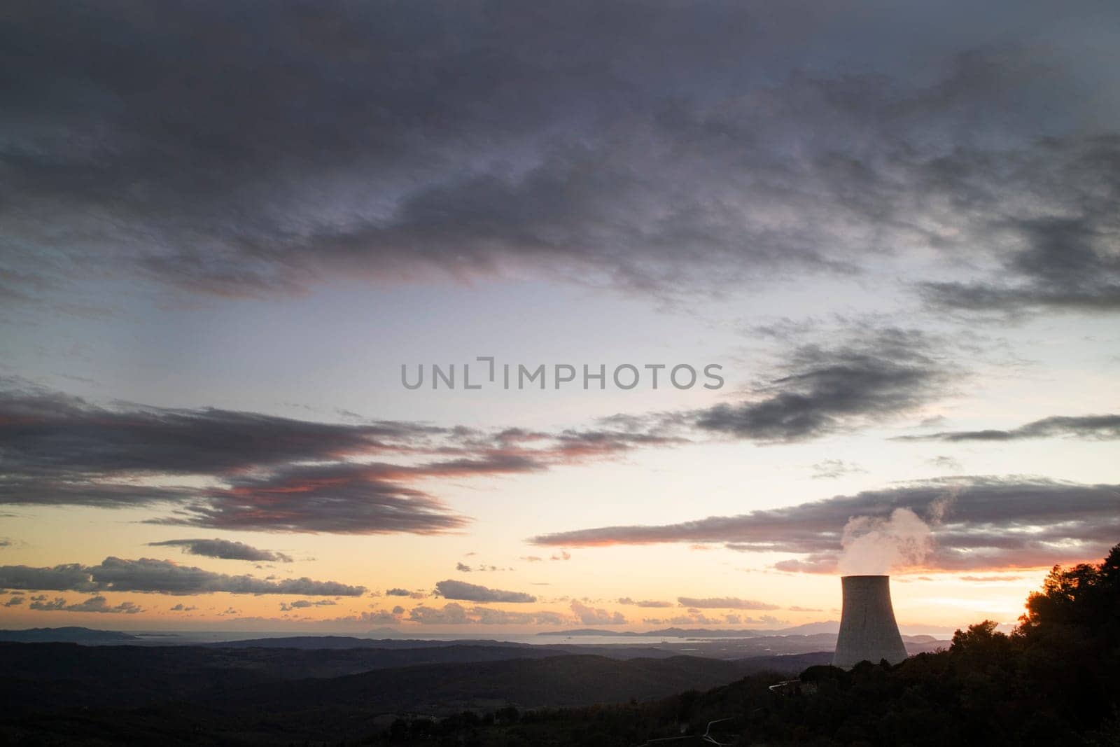 Sunset at the power plant for the exploitation of boraciferous blowers for the production of electricity in Tuscany, Italy 