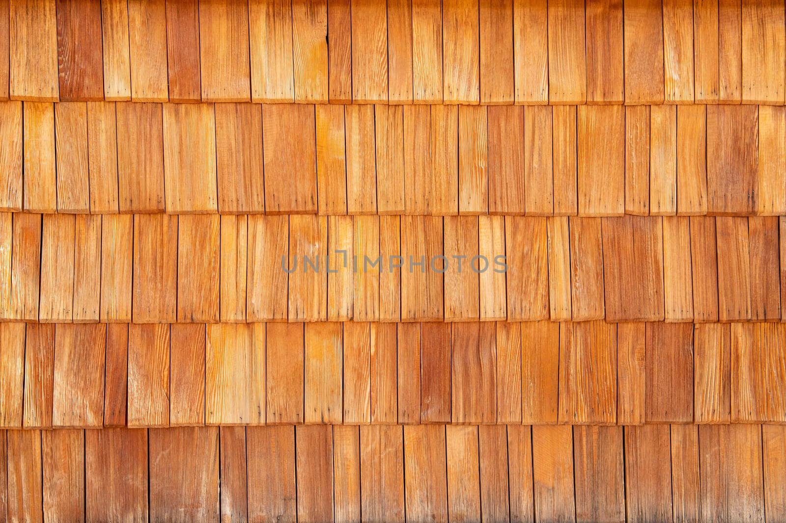 Wooden shingle roof tile background, rural construction.